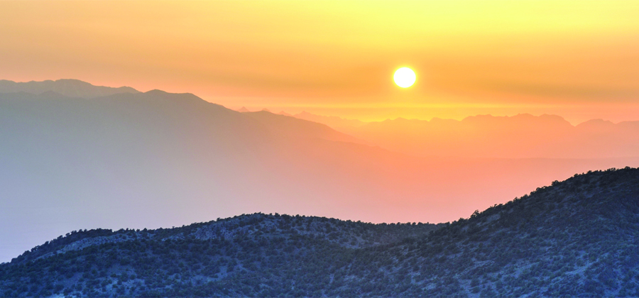 Sun rising over hills