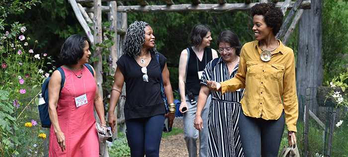 Women walking through arbor