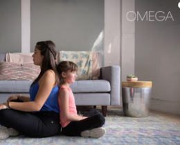 Woman and child sitting back-to-back