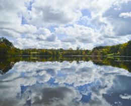 Cloudy sky reflecting on calm lake