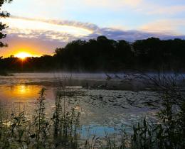 Sun sets over lake