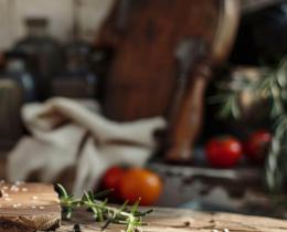 Rustic wooden table with olive oil, artisanal bread, rosemary, and aged cheese—capturing the essence of Leonardo da Vinci's Mediterranean-inspired diet focused on fresh, wholesome, natural foods and healthy fats.