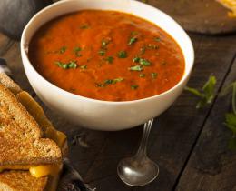 A bowl of tomato soup and a grilled cheese sandwich