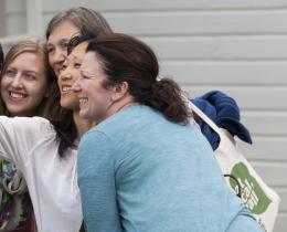 Group of women over 40 smiling and taking a selfie, representing empowerment, community, and support through menopause and midlife transitions.