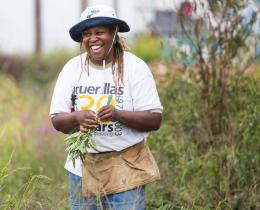 Karen Washington harvesting sage in a field