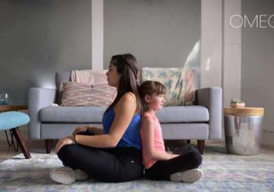 Woman and child sitting back-to-back