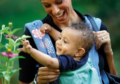 Mother and baby looking at flowers