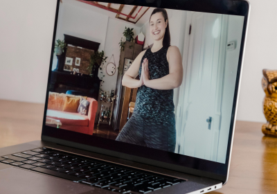 Woman teaching yoga on a laptop screen