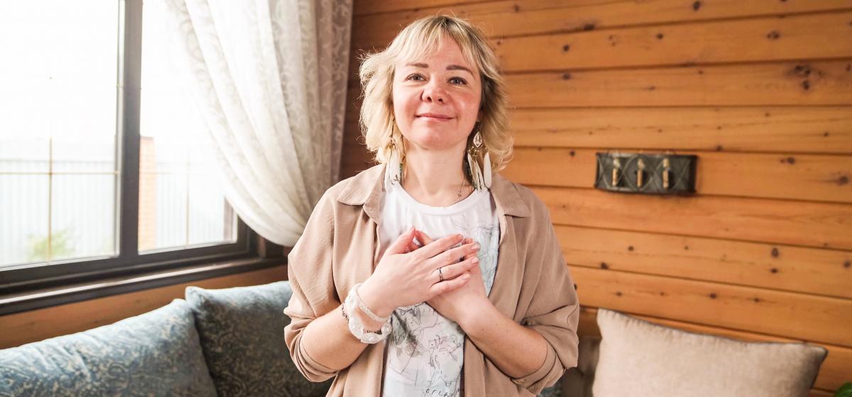 Woman with hands over heart in gratitude