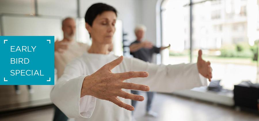 Woman in a qigong pose in a classroom