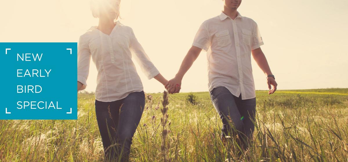 New Early Bird Special. Couple walking in a field at sunset