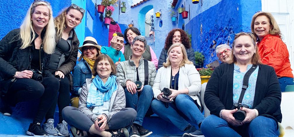 Group of workshop participants with cameras in a colorful street