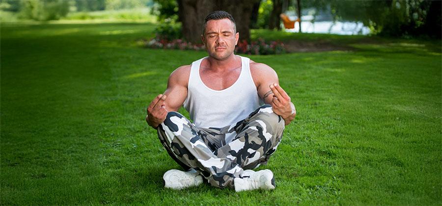 Veteran meditating in a grassy field