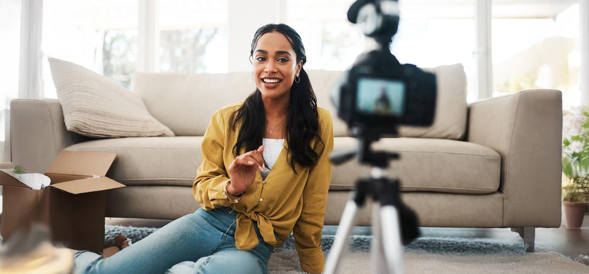 Content creator filming a video in her living room