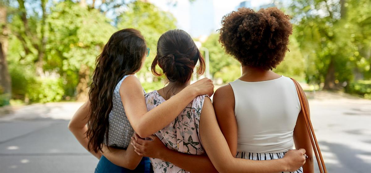 Women hugging in a park