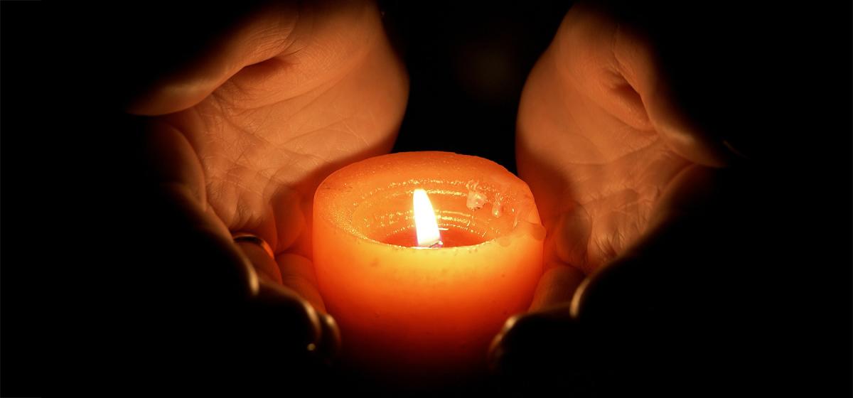 Hands holding a candle