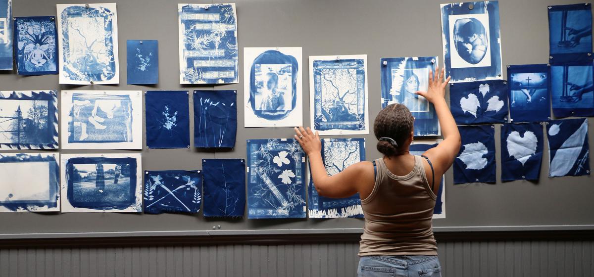 Naima Green in a gallery full of cyanotype prints