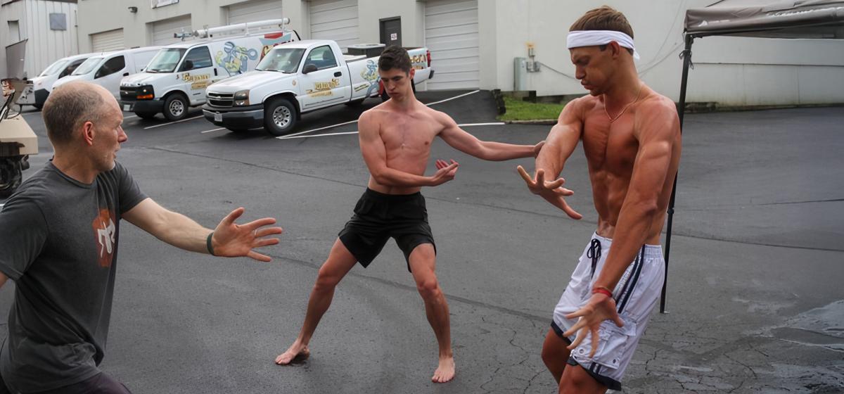 Bob Souillere leading a movement exercise in a parking lot