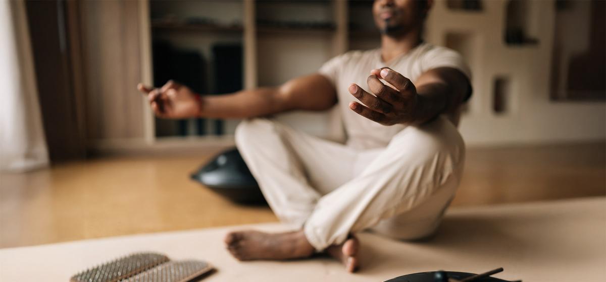 Person meditating in living room