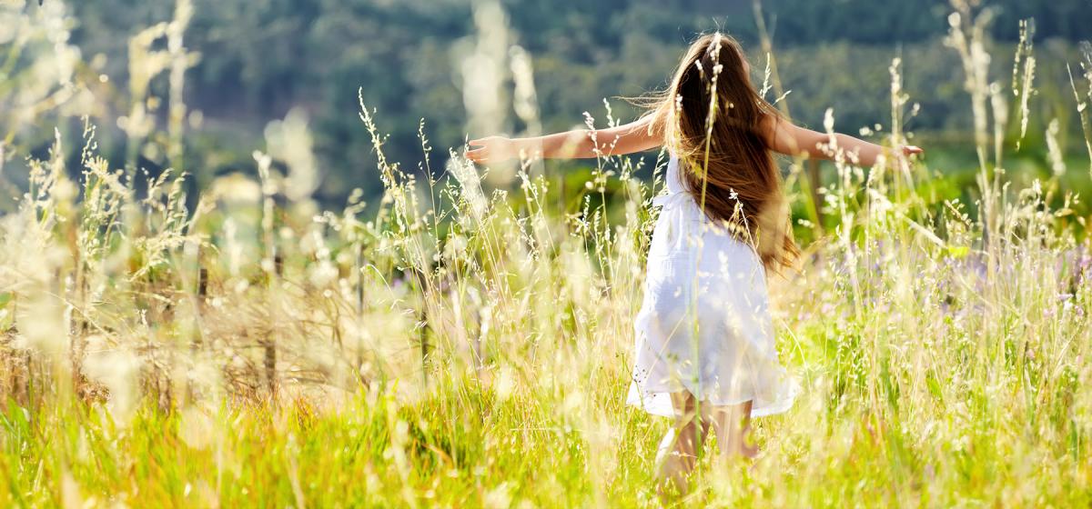 Woman dancing in a brightly lit field