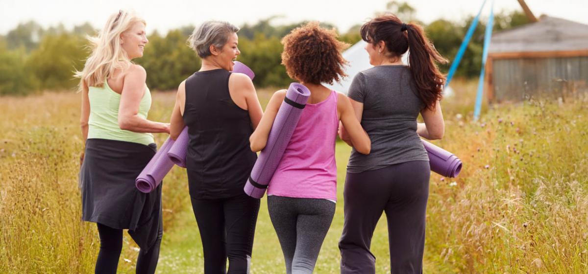 Group of women with yoga mats outside