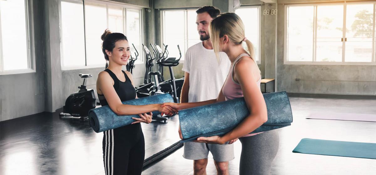 People shaking hands in a yoga studio