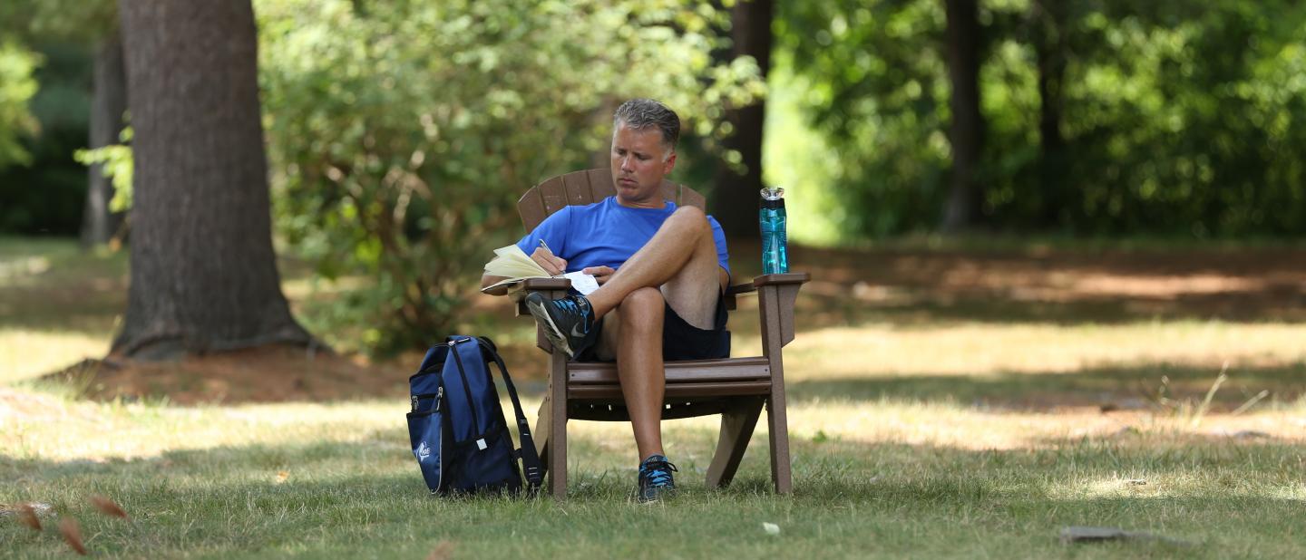 Man writing in chair