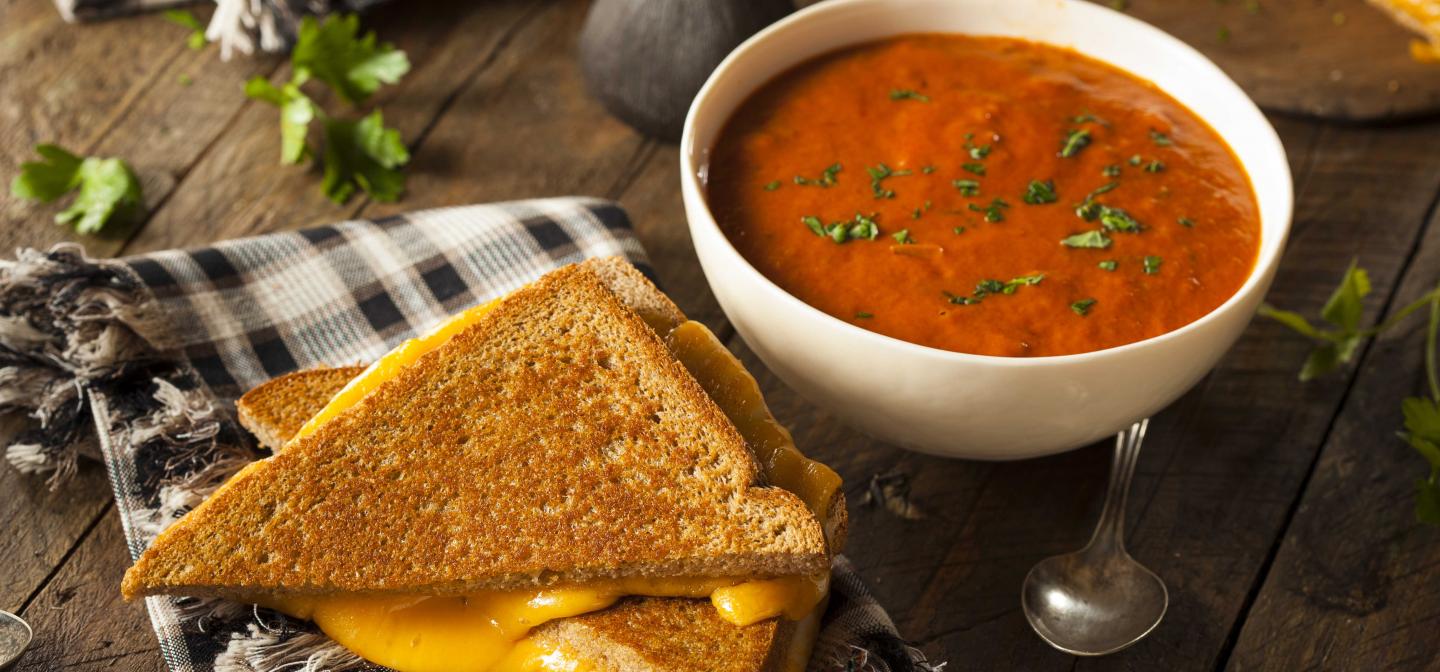 A bowl of tomato soup and a grilled cheese sandwich