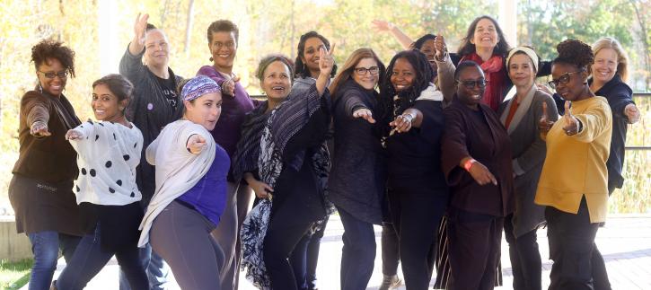 Group of women smiling and pointing at camera